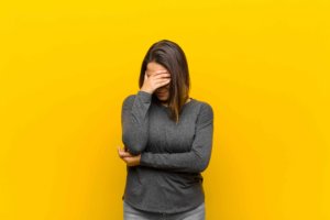 yellow background of embarrassed girl 